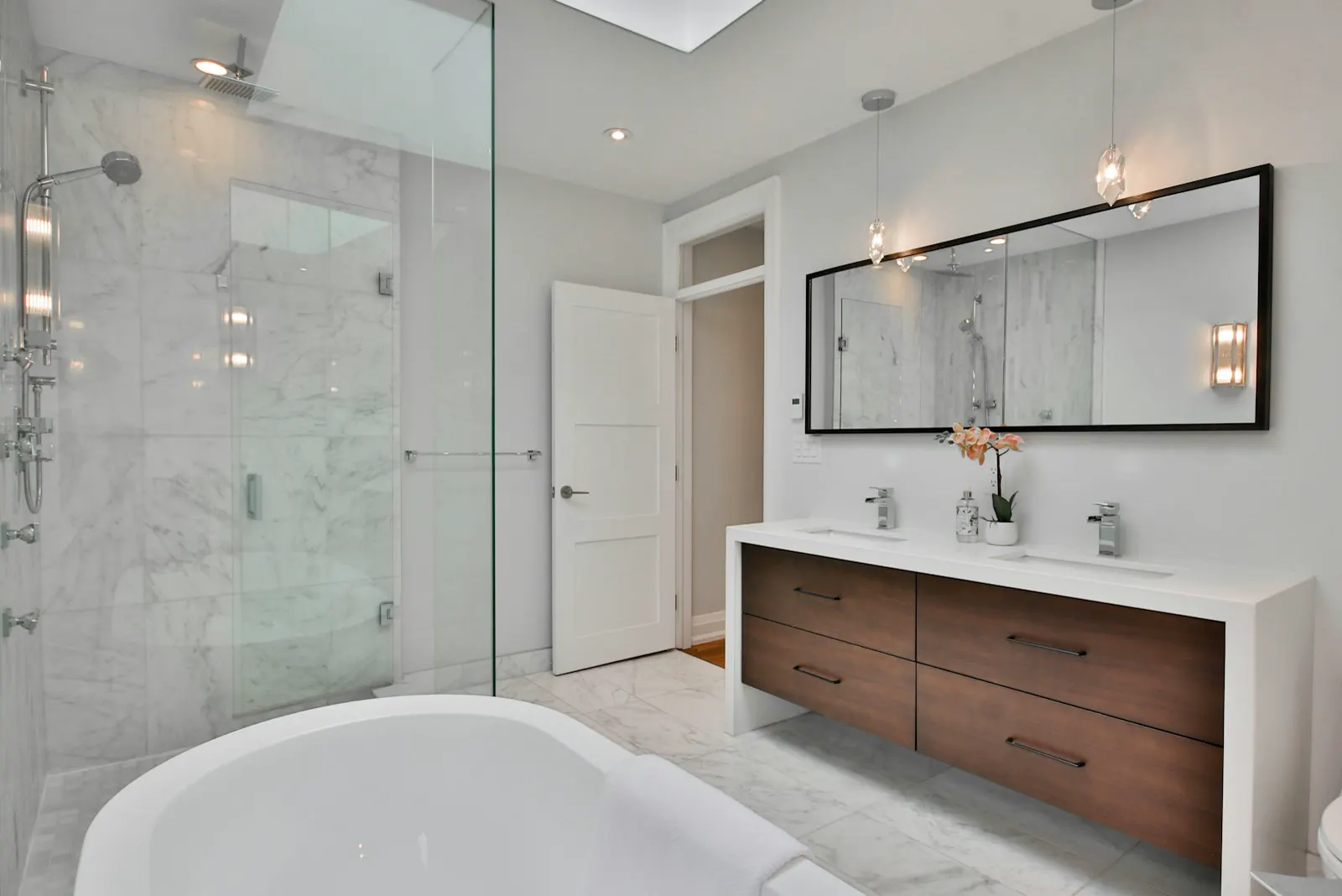 Spa bath with walnut vanity and glass shower