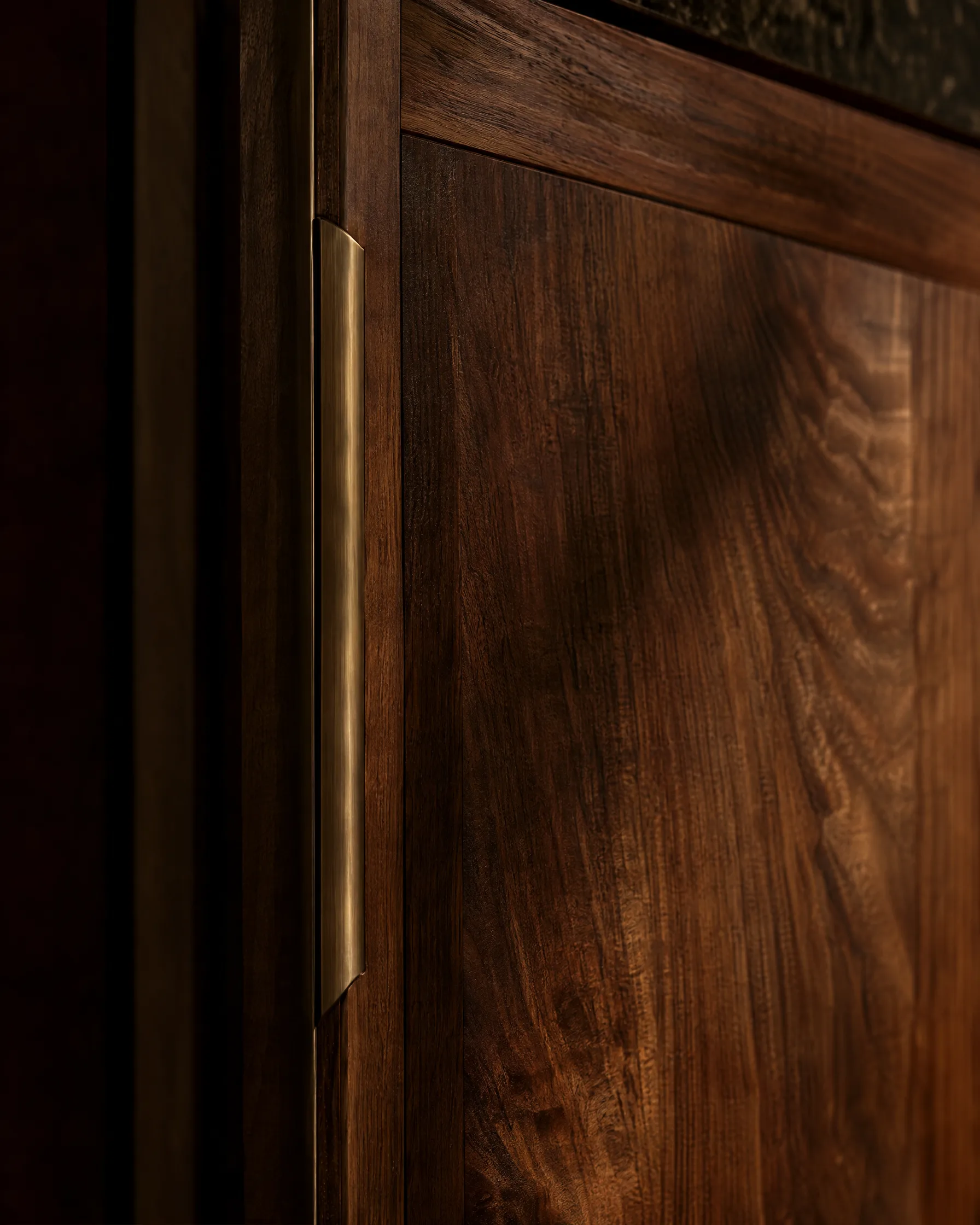 Quarter-sawn walnut cabinet door with bronze pull